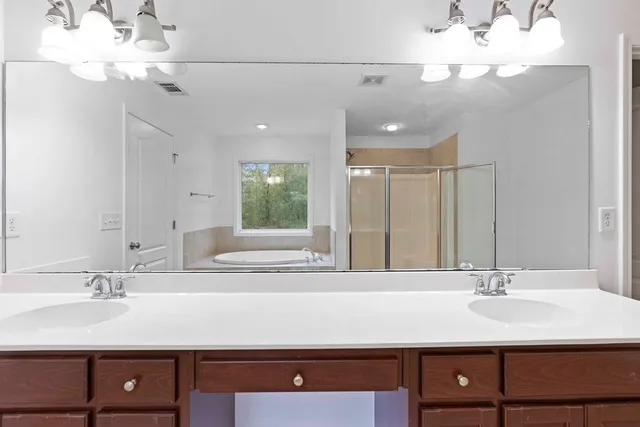 a bathroom with a sink vanity and a mirror