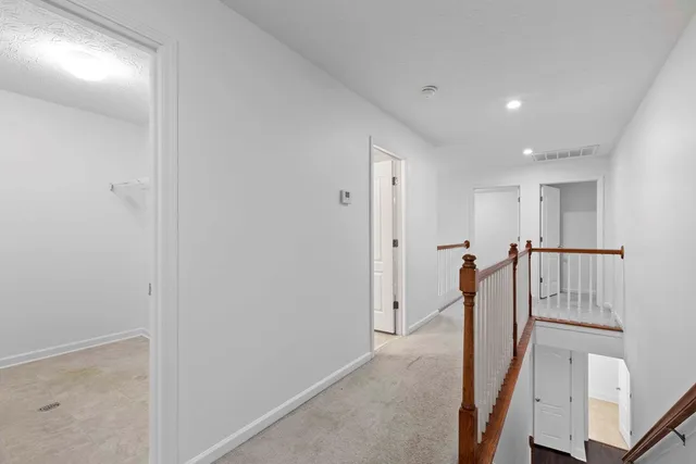 a view of hallway with furniture
