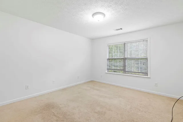 an empty room with a empty space and windows