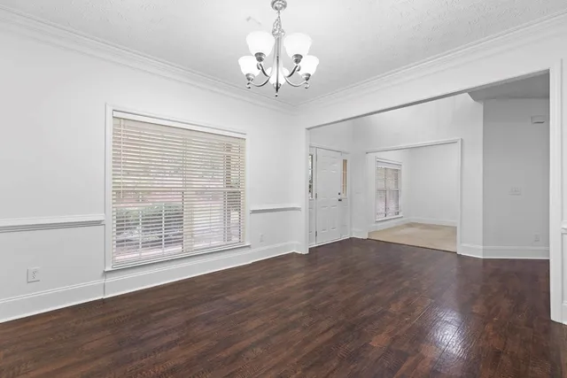 a view of wooden floor and windows in a room