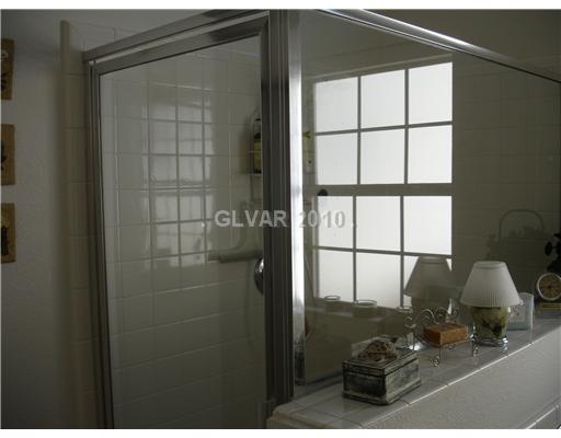 5205 Rim View Lane Las Vegas, NV 89130 - Photo 16 of 25 Master Bath/Spa. Master Shower - reflection of the window is from above the garden tub.