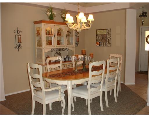 5205 Rim View Lane Las Vegas, NV 89130 - Photo 6 of 25 Dining Room. This is the view from the Great Room to the Dining Room. Columns separate the areas with pot shelves for displaying treasures above.