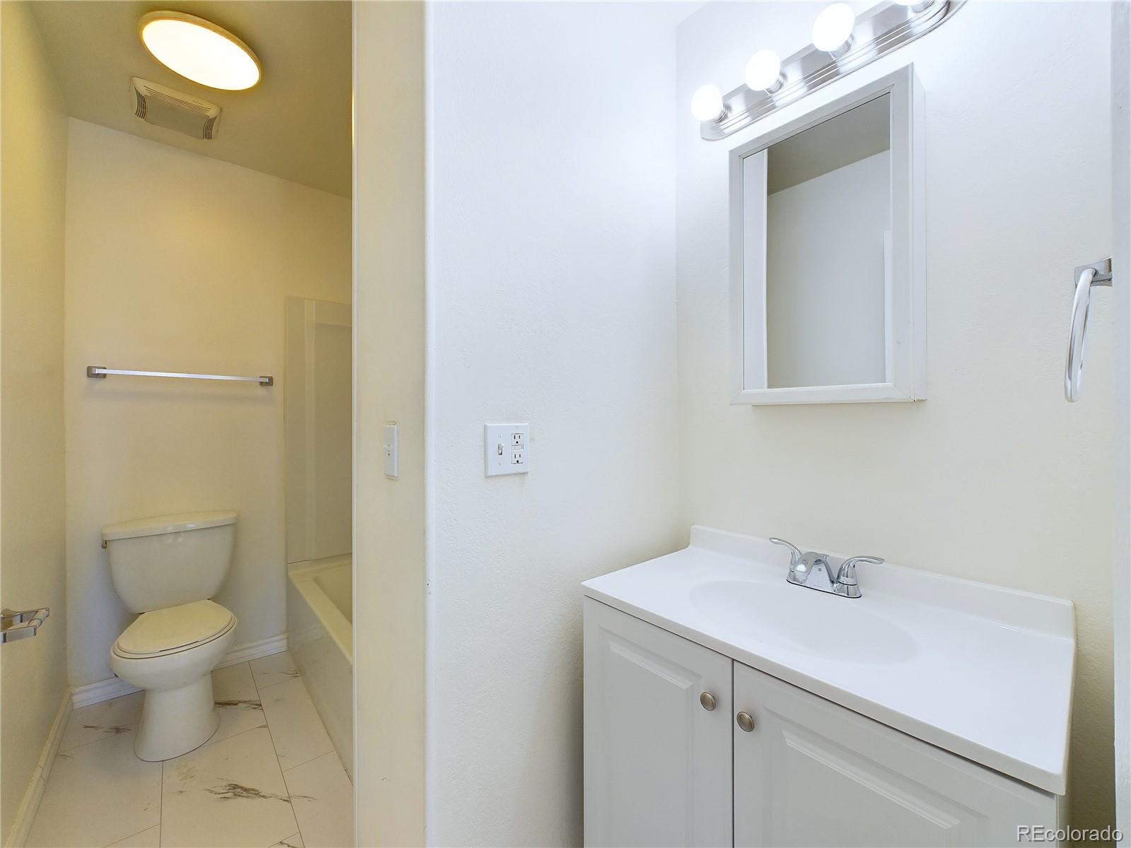 8770 Rainbow Avenue, Unit B4 Denver, CO 80229 - Photo 16 of 29 a bathroom with a sink a toilet and shower