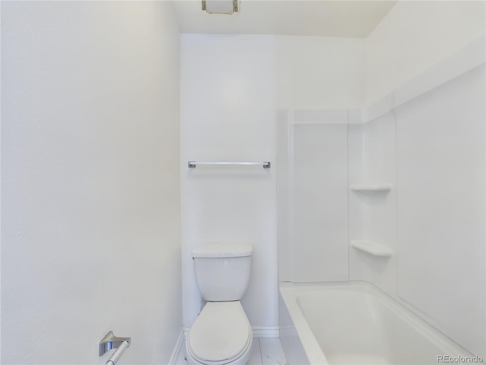 8770 Rainbow Avenue, Unit B4 Denver, CO 80229 - Photo 17 of 29 a white toilet sitting next to a bath tub