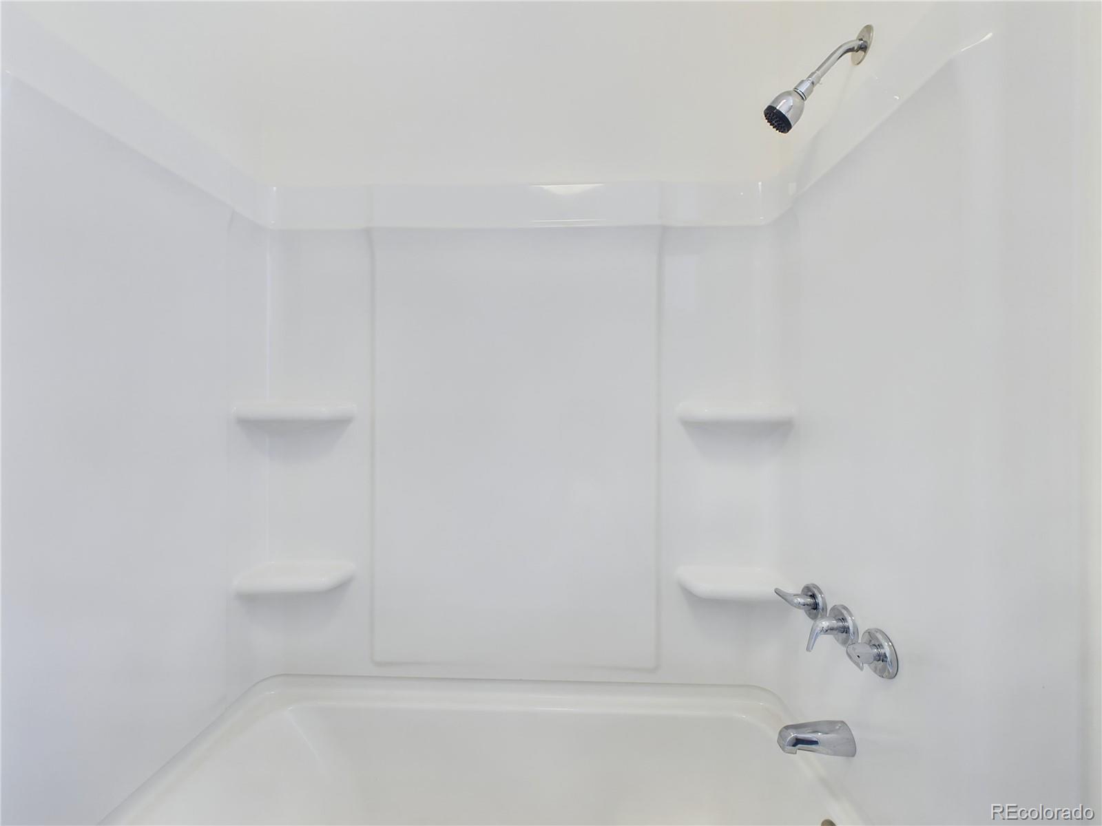 8770 Rainbow Avenue, Unit B4 Denver, CO 80229 - Photo 18 of 29 a close up of a bathtub