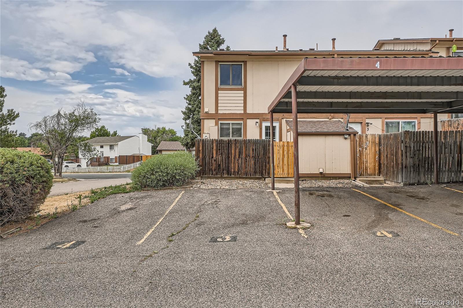 8770 Rainbow Avenue, Unit B4 Denver, CO 80229 - Photo 24 of 29 front view of a house with a garage