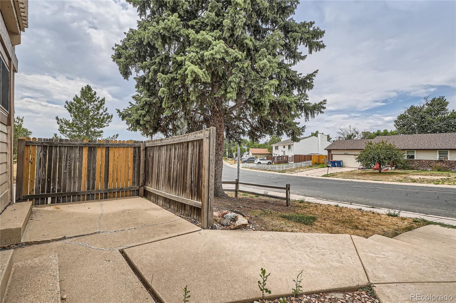 8770 Rainbow Avenue, Unit B4 Denver, CO 80229 - Photo 25 of 29 a view of a yard with wooden fence