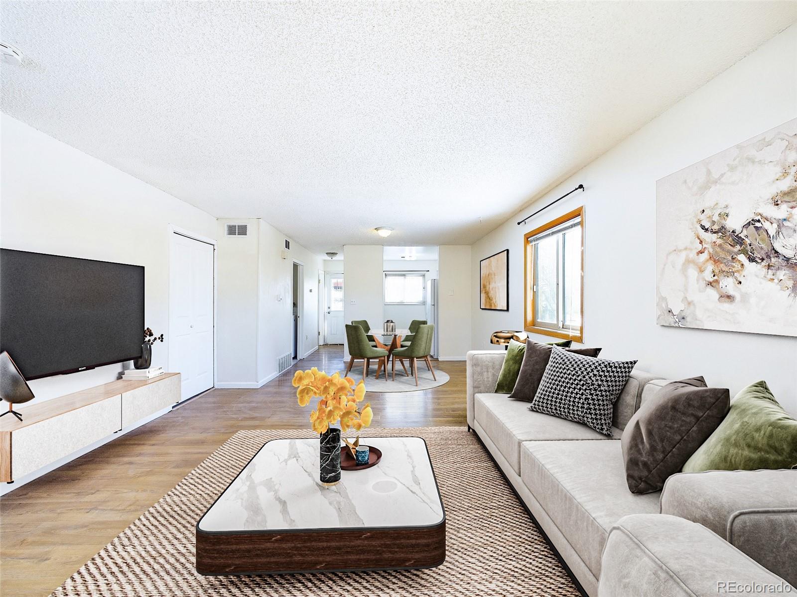 8770 Rainbow Avenue, Unit B4 Denver, CO 80229 - Photo 4 of 29 a living room with furniture and a flat screen tv