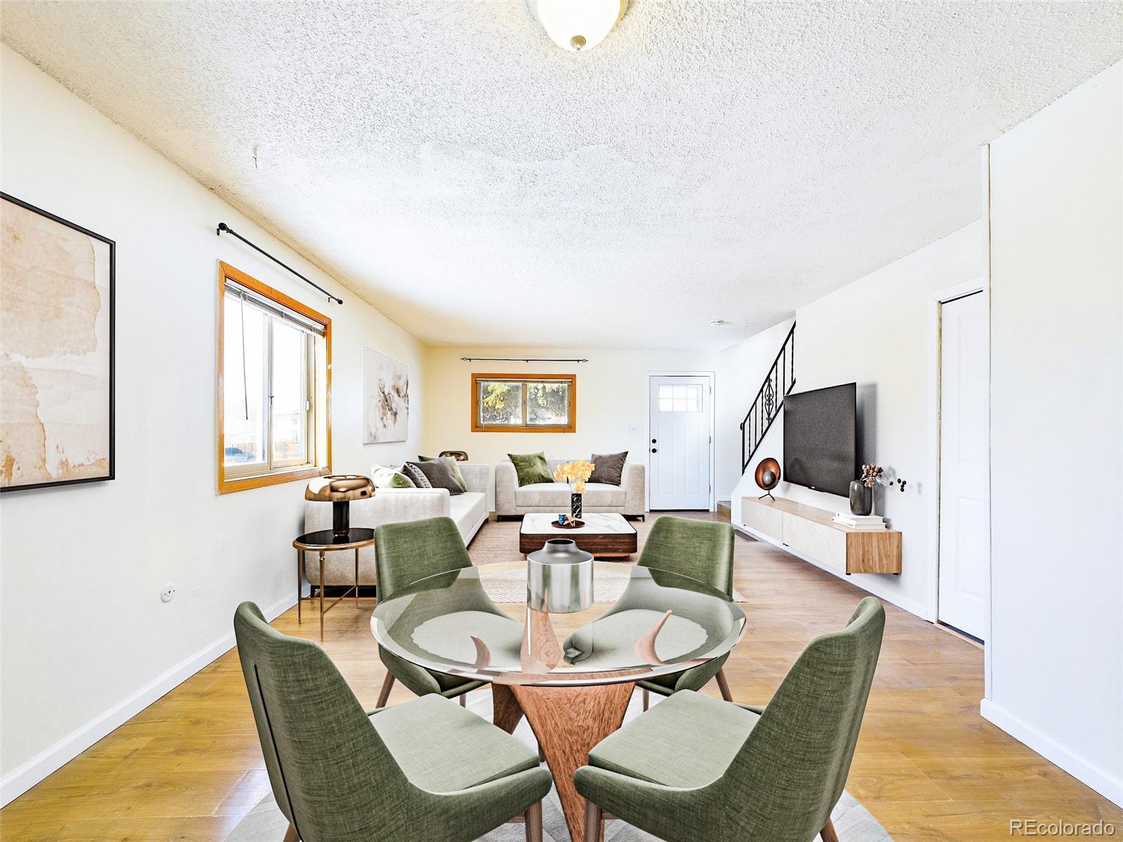 8770 Rainbow Avenue, Unit B4 Denver, CO 80229 - Photo 5 of 29 a living room with furniture and a flat screen tv