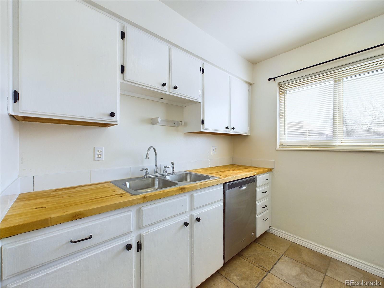8770 Rainbow Avenue, Unit B4 Denver, CO 80229 - Photo 8 of 29 a kitchen with a sink cabinets and window