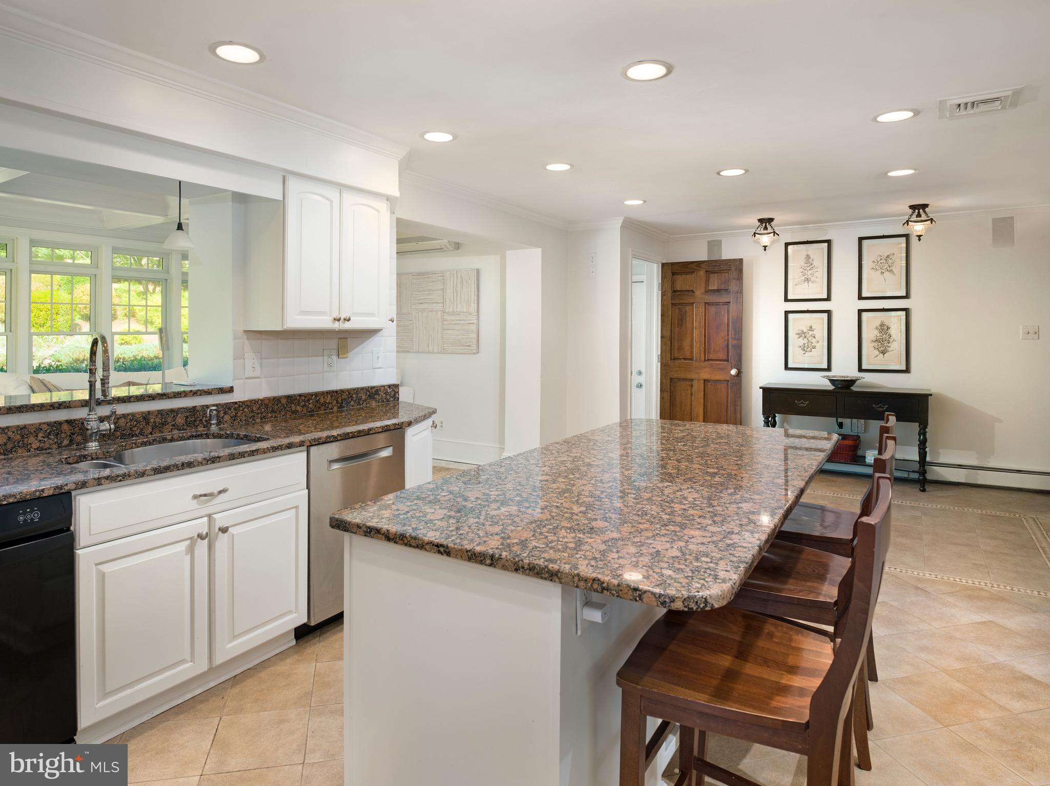 870 Goshen Road Newtown Square, PA 19073 - Photo 12 of 31 a kitchen with granite countertop kitchen island sink stove and white cabinets