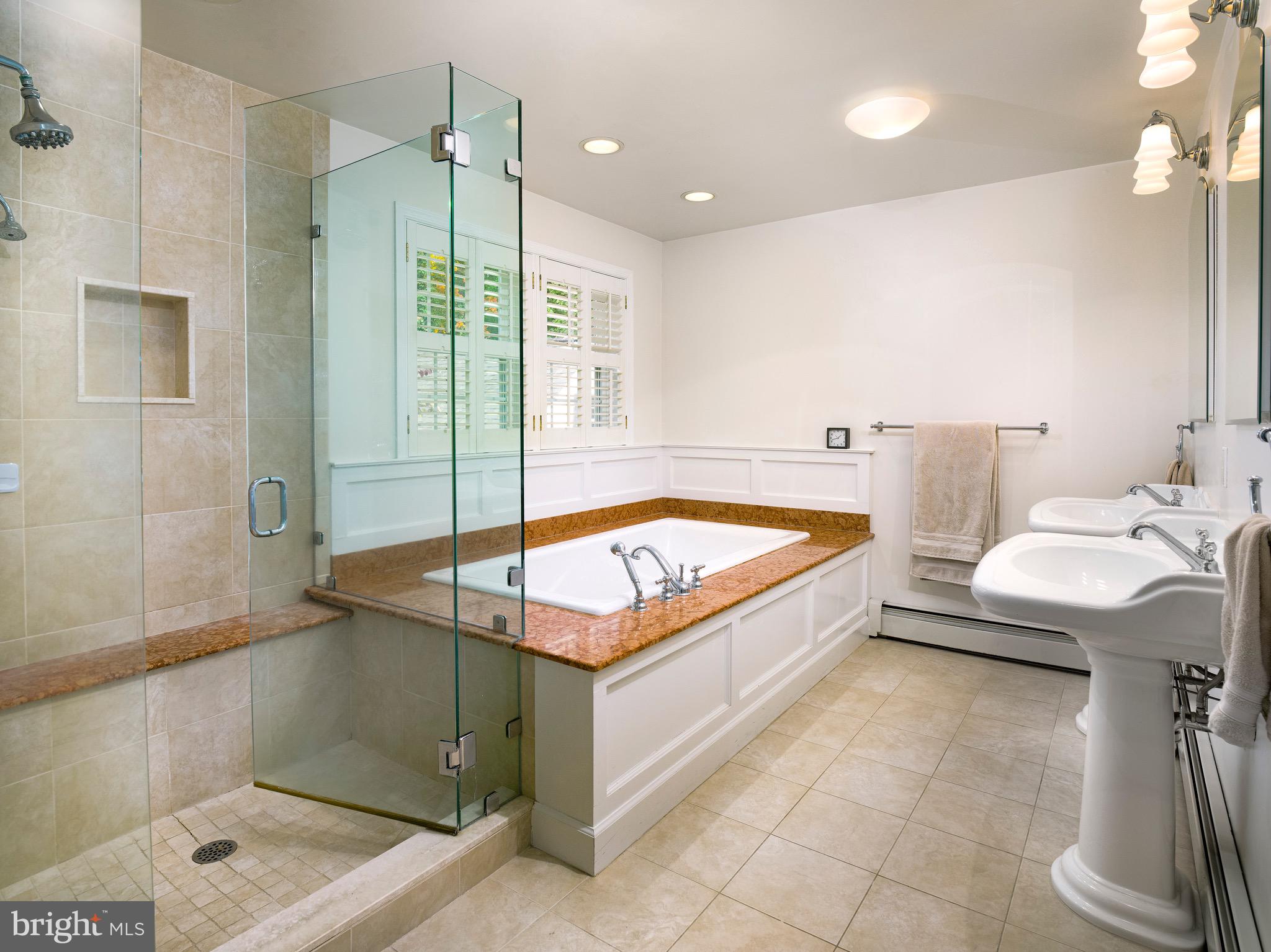 870 Goshen Road Newtown Square, PA 19073 - Photo 18 of 31 a bathroom with a tub a sink and shower