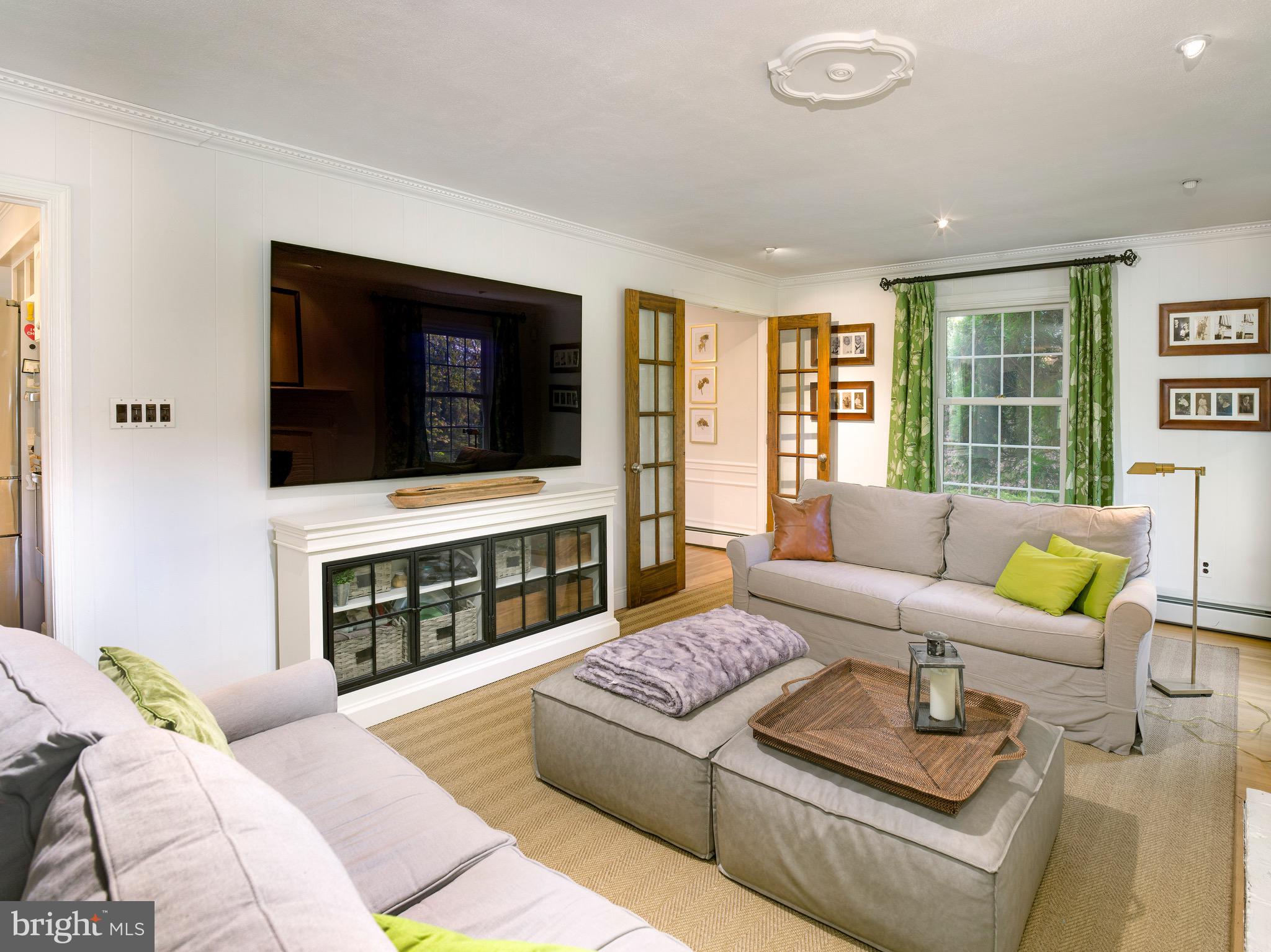 870 Goshen Road Newtown Square, PA 19073 - Photo 7 of 31 a living room with furniture a flat screen tv and a fireplace