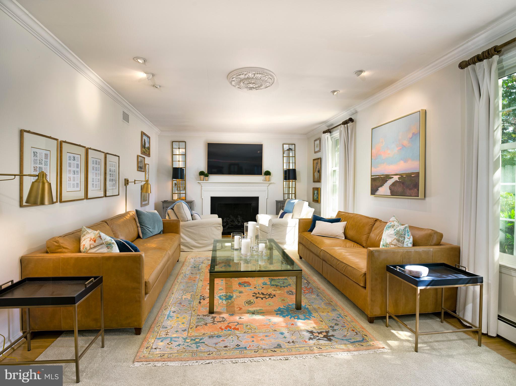 870 Goshen Road Newtown Square, PA 19073 - Photo 9 of 31 a living room with furniture flat screen tv and a fireplace