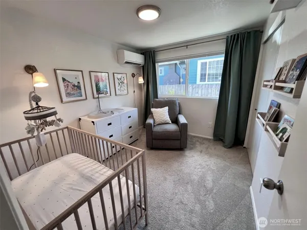a bedroom with furniture and a large window