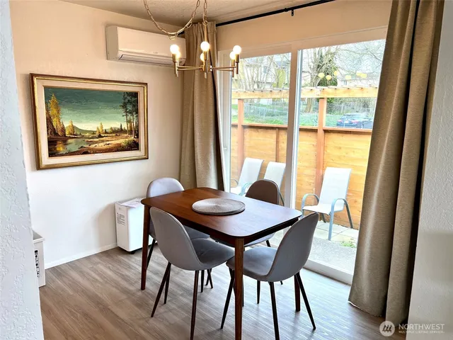 a view of a dining room with furniture window and wooden floor