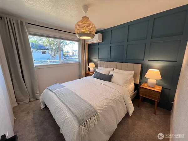 a bedroom with a bed and a window