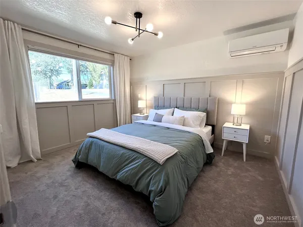 a spacious bedroom with a bed and a window