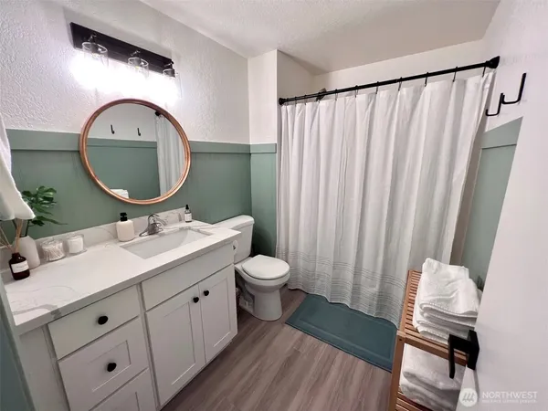 a bathroom with a toilet a sink and a mirror