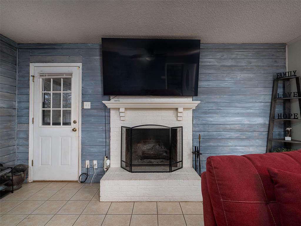9663 Matise Street Tyler, TX 75706 - Photo 5 of 15 a living room with furniture a flat screen tv and a fireplace