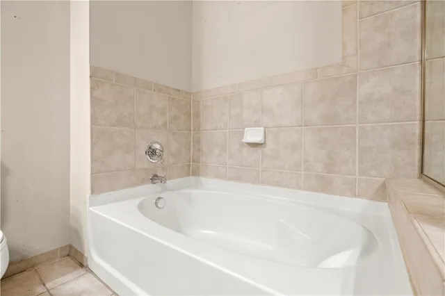 a white bath tub sitting in a bathroom