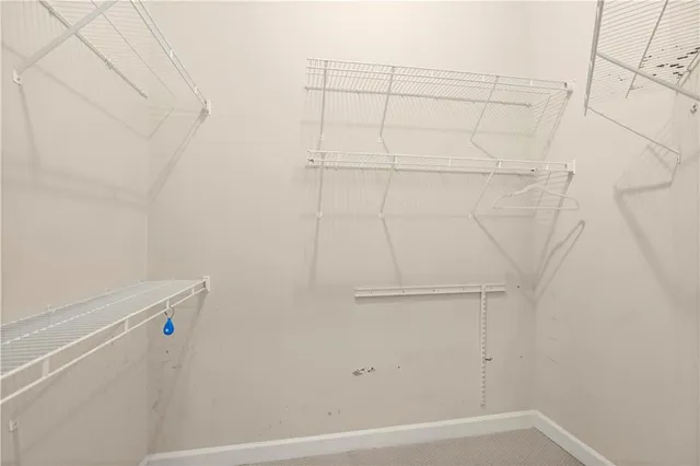 an empty room with a empty space and chandelier fan