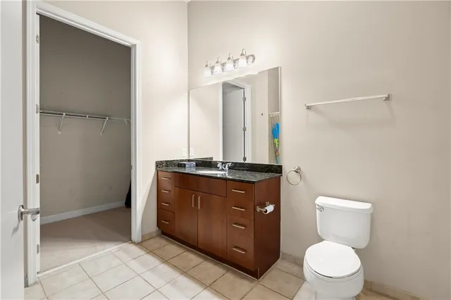 a view of walk in closet with clothes