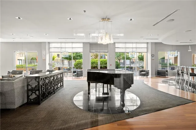 a living room with furniture and a chandelier