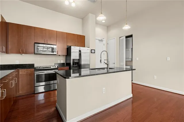 a kitchen with stainless steel appliances and a refrigerator