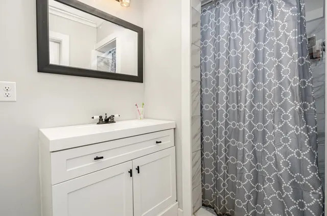 a view of bathroom with shower curtain