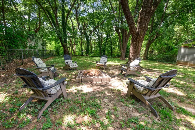 a view of a backyard with sitting area