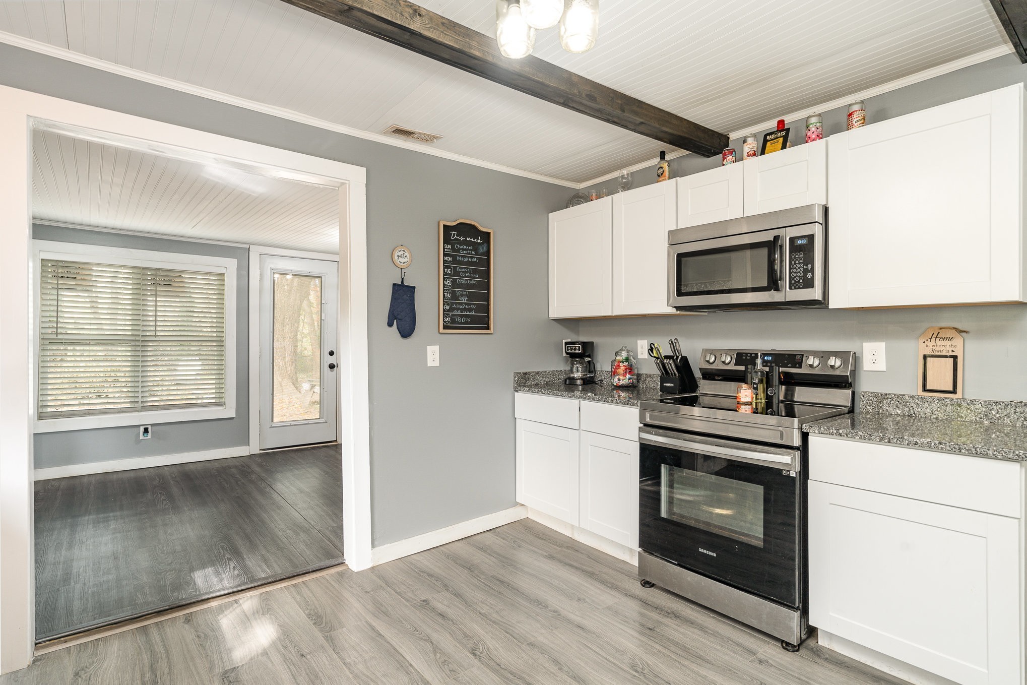 104 Morningside Drive Portland, TN 37148 - Photo 5 of 19 a kitchen with stainless steel appliances granite countertop a stove a microwave and a refrigerator