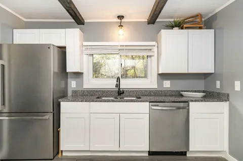 a kitchen with appliances cabinets and a counter top space