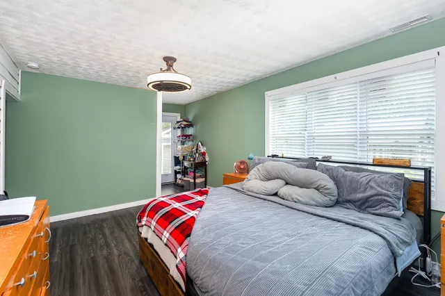 a bedroom with a bed and a chandelier