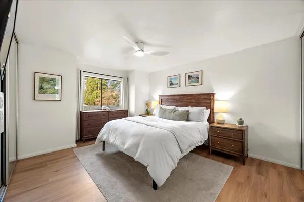 a bedroom with a bed and painting on the wall