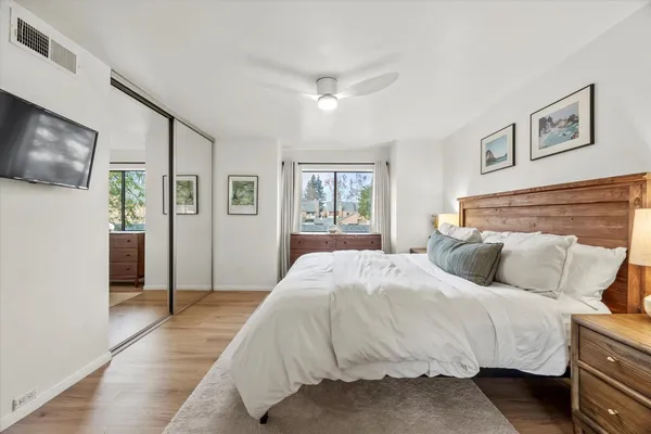 a bedroom with a large bed and flat screen tv