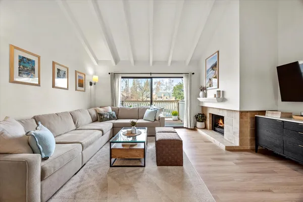 a living room with furniture a fireplace and a flat screen tv