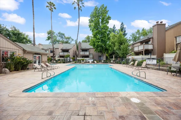 a swimming pool with outdoor seating and yard