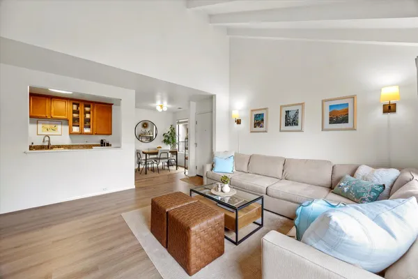 a living room with furniture and painting on the wall