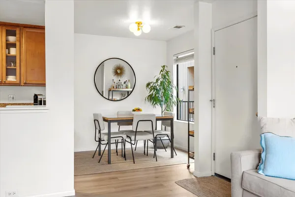 a view of a dining room with furniture and wooden floor