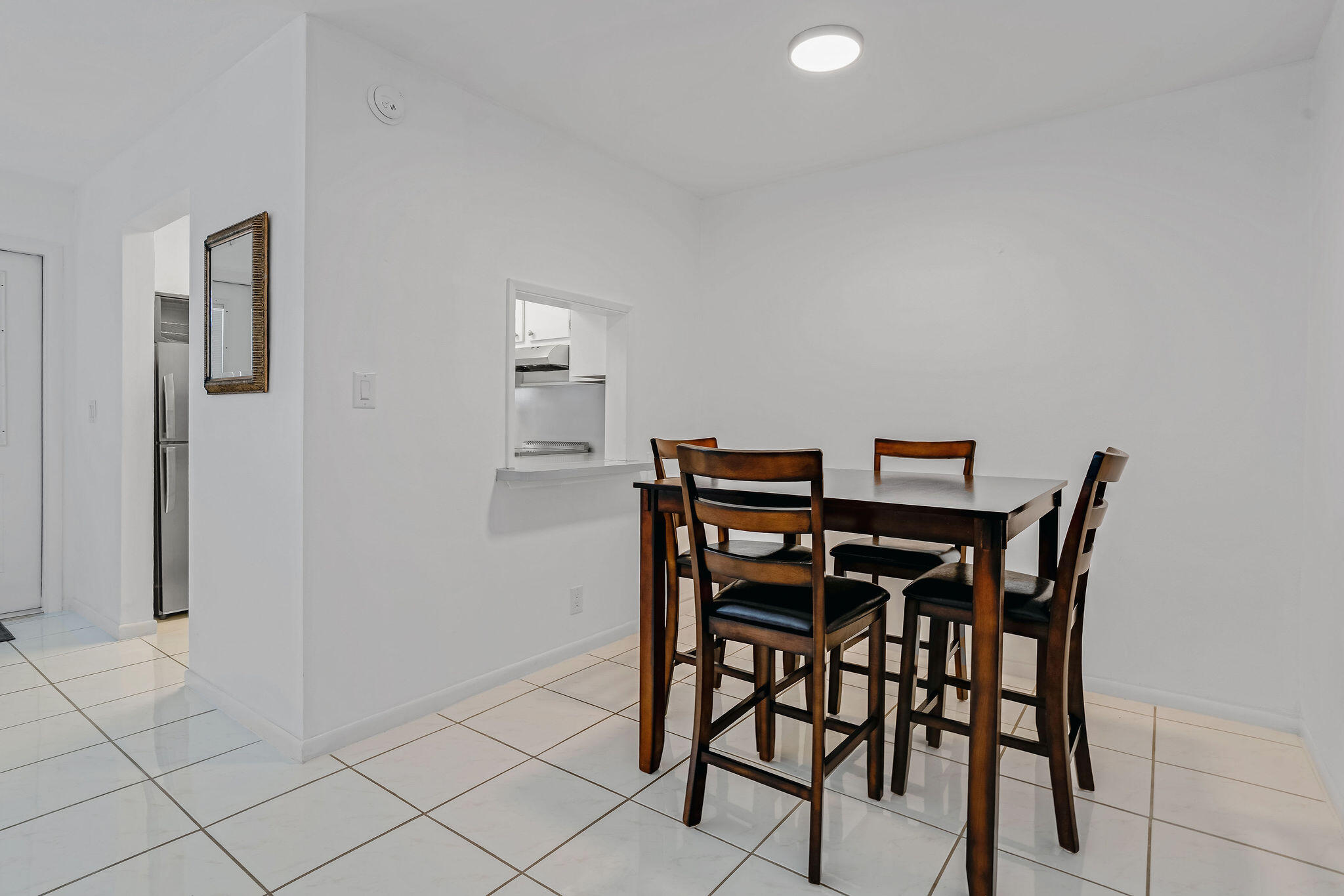 2050 Northeast 39th Street, Unit E307 Lighthouse Point, FL 33064 - Photo 14 of 42 a view of a dining room with furniture