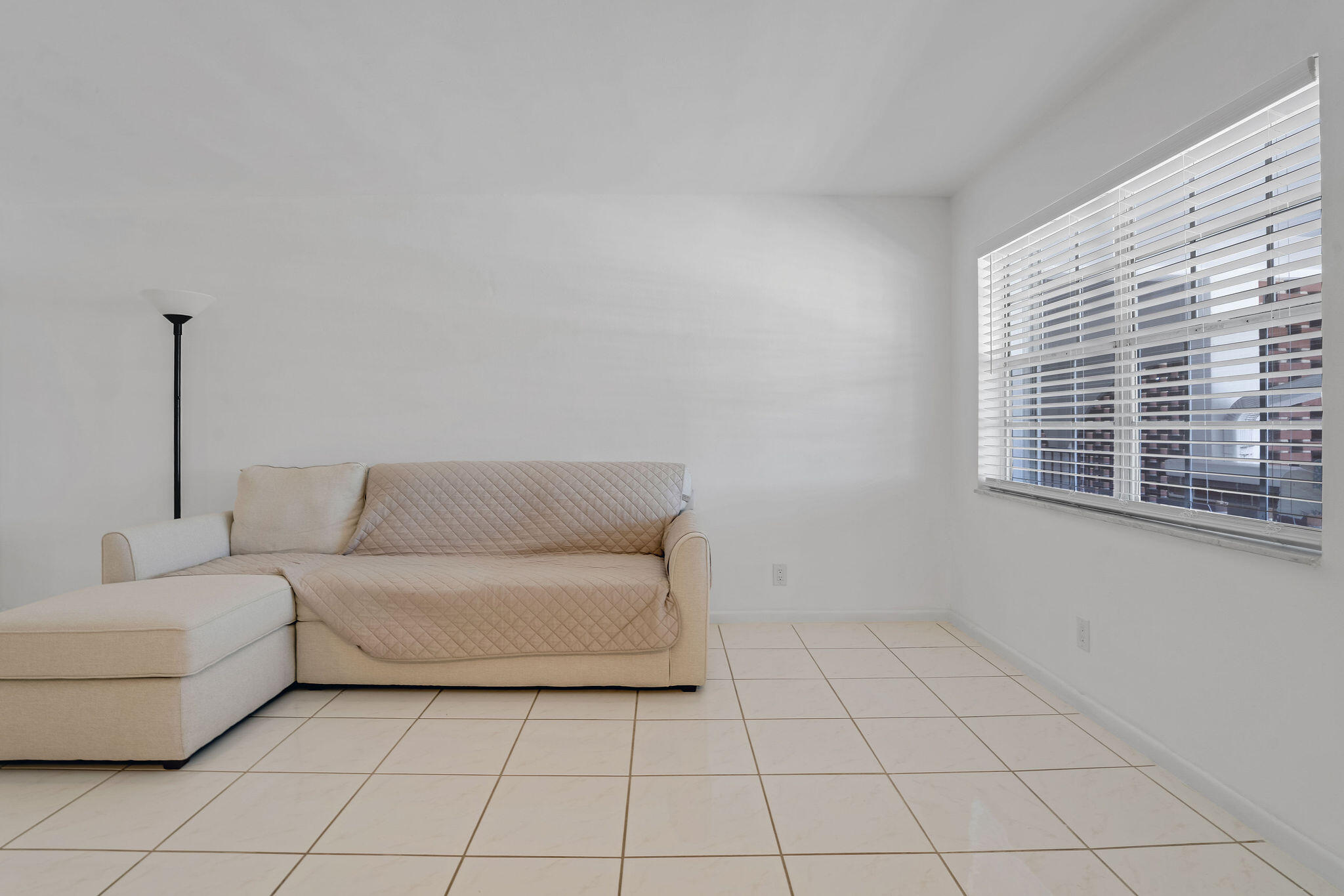 2050 Northeast 39th Street, Unit E307 Lighthouse Point, FL 33064 - Photo 19 of 42 a living room with furniture and a window