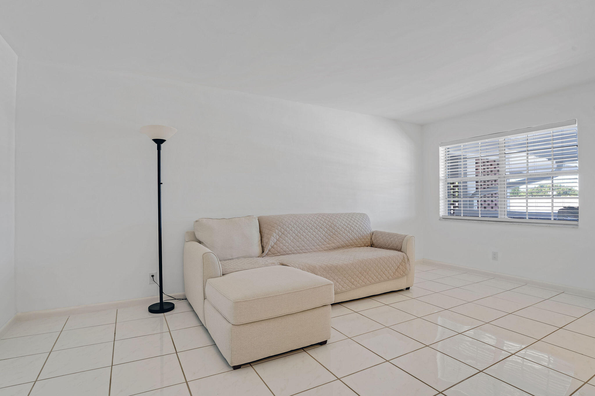2050 Northeast 39th Street, Unit E307 Lighthouse Point, FL 33064 - Photo 20 of 42 a living room with furniture and window
