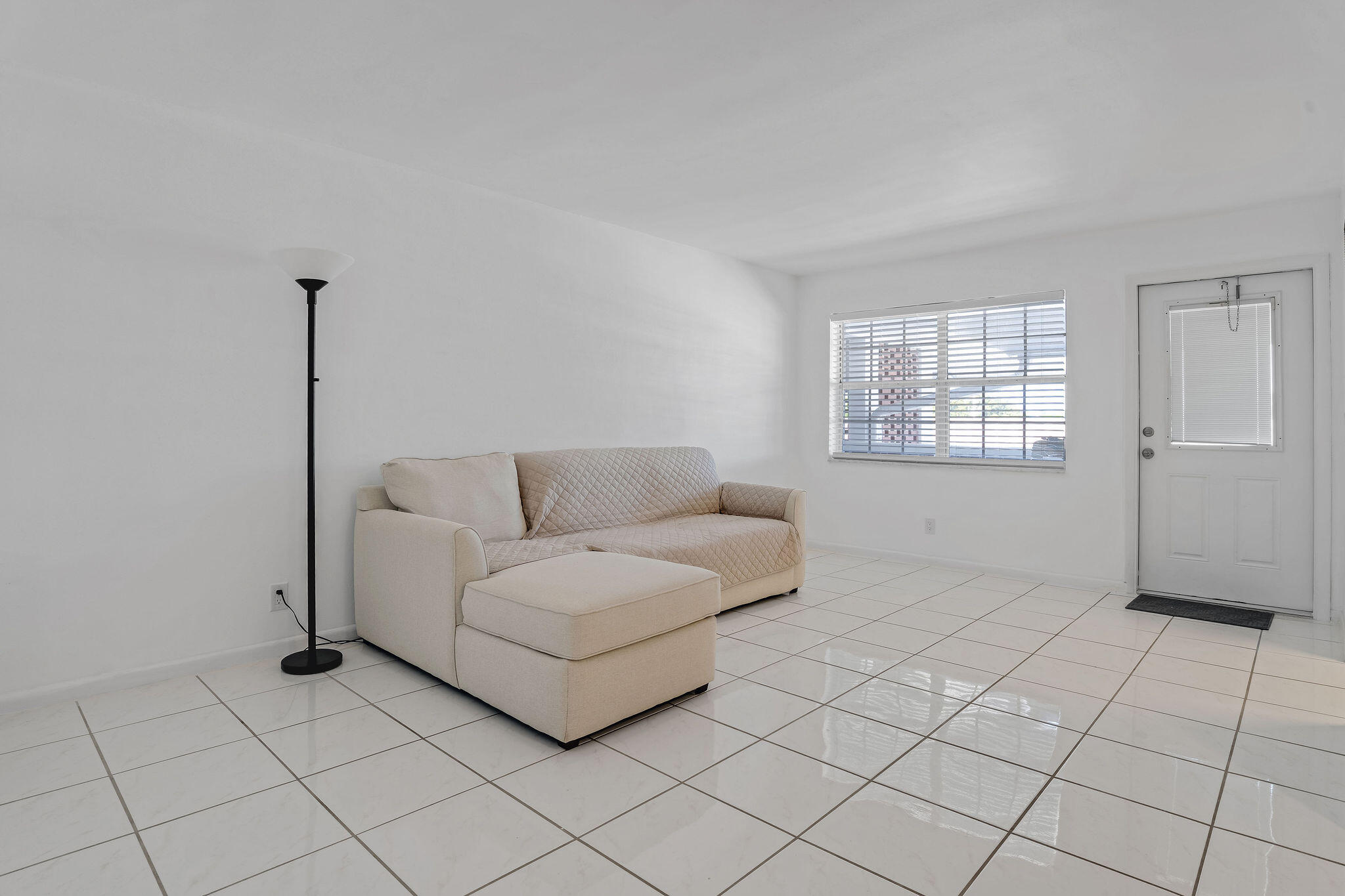 2050 Northeast 39th Street, Unit E307 Lighthouse Point, FL 33064 - Photo 21 of 42 a living room with furniture and a window