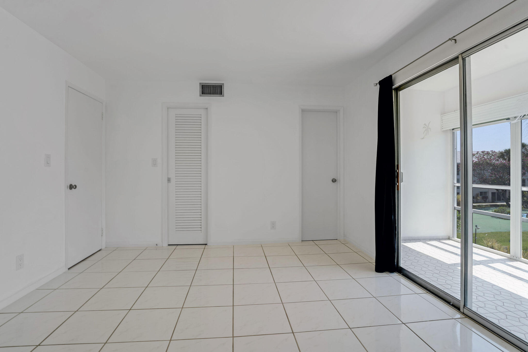 2050 Northeast 39th Street, Unit E307 Lighthouse Point, FL 33064 - Photo 22 of 42 a view of an empty room and window in a room