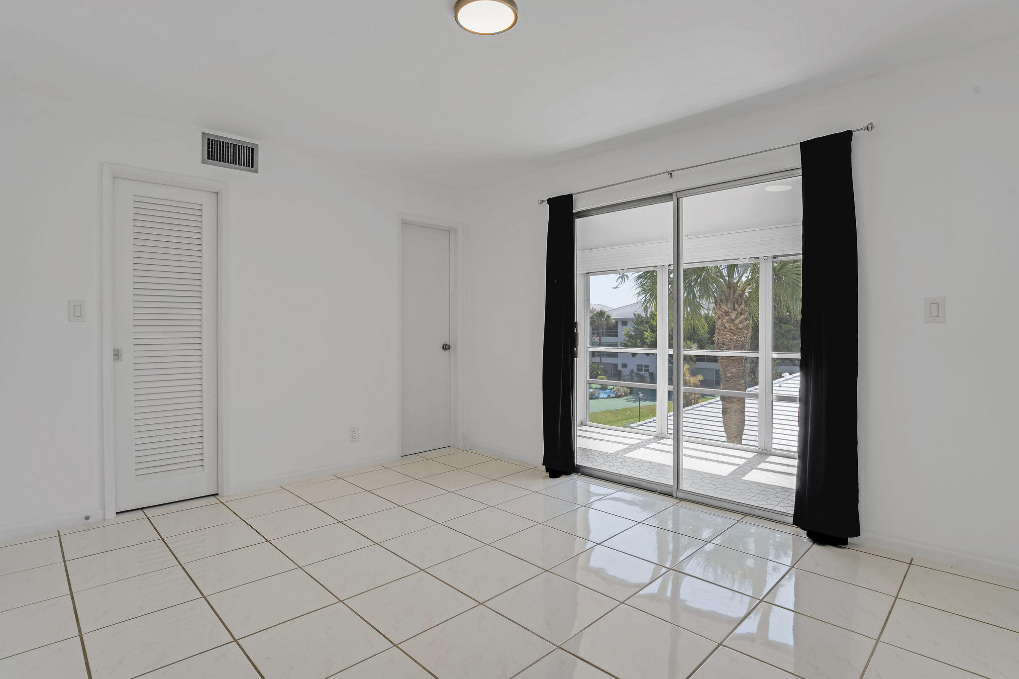 2050 Northeast 39th Street, Unit E307 Lighthouse Point, FL 33064 - Photo 23 of 42 a view of an empty room and window