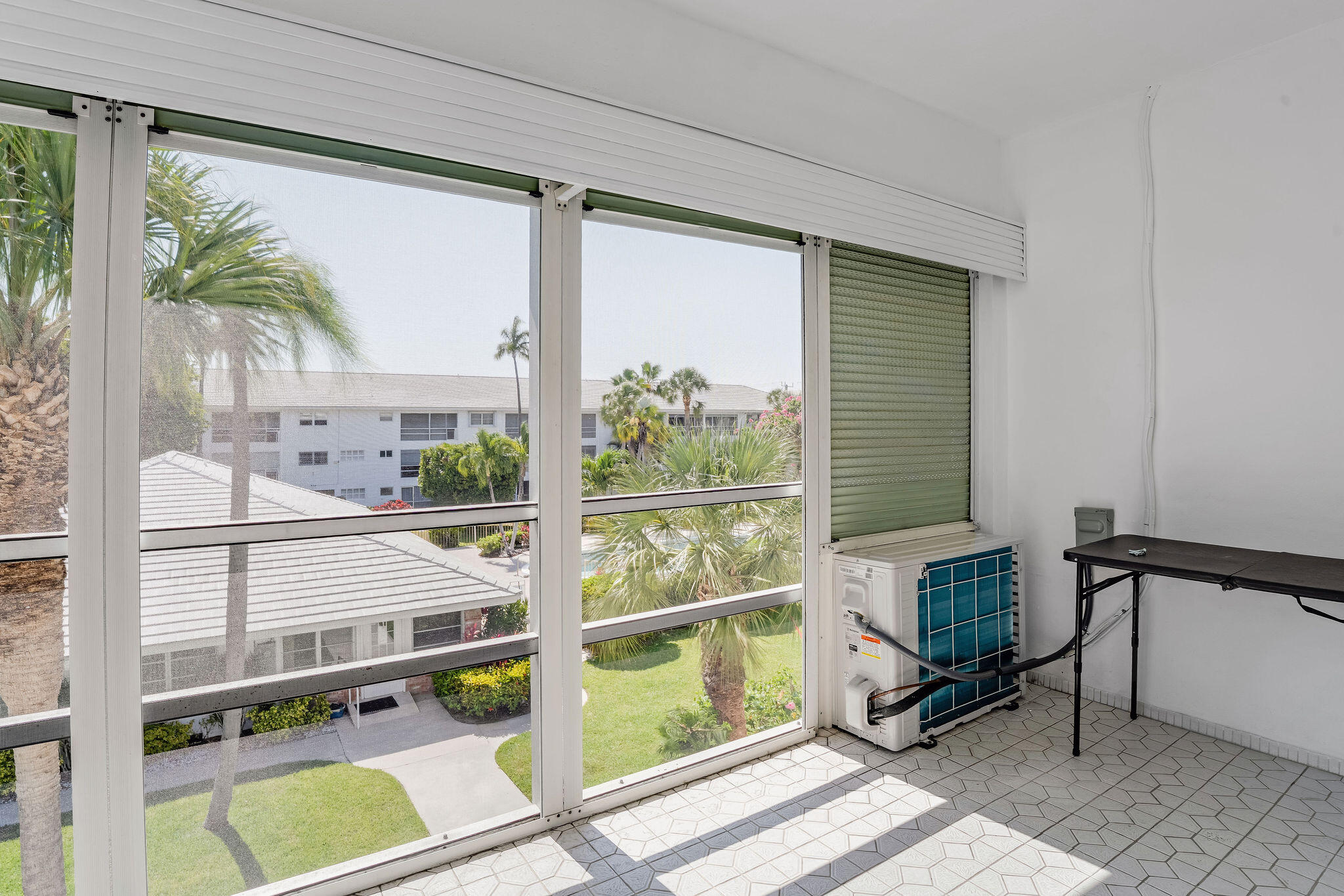 2050 Northeast 39th Street, Unit E307 Lighthouse Point, FL 33064 - Photo 30 of 42 a view of a room with a large window and sitting area