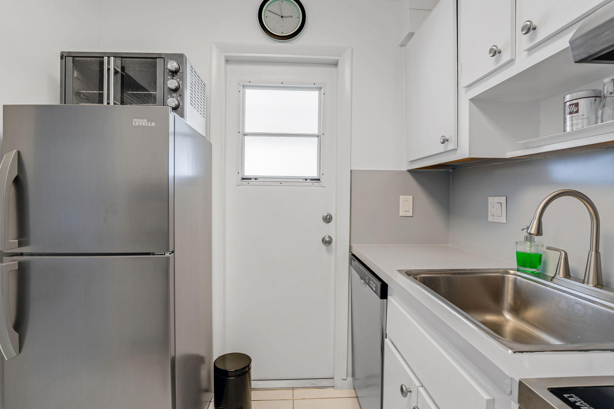 2050 Northeast 39th Street, Unit E307 Lighthouse Point, FL 33064 - Photo 4 of 42 a kitchen with stainless steel appliances granite countertop a refrigerator sink and cabinets