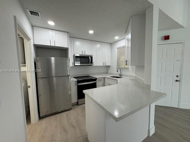 18344 Northwest 68th Avenue, Unit K Hialeah, FL 33015 - Photo 2 of 9 a kitchen with stainless steel appliances granite countertop a refrigerator a sink a stove a microwave and a refrigerator