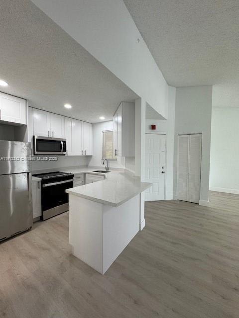 18344 Northwest 68th Avenue, Unit K Hialeah, FL 33015 - Photo 9 of 9 a large kitchen with a stove and a refrigerator